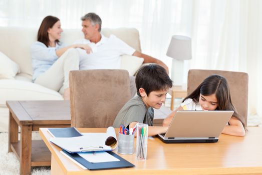 Children working on their laptop at home