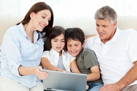 Family looking at  the laptop at home