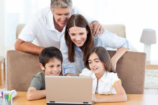 Family looking at the laptop at home