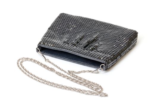 Classic black handbag with a silver chain strap on a white studio background