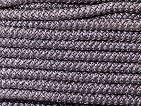Abstract background of braided interwoven dark cord