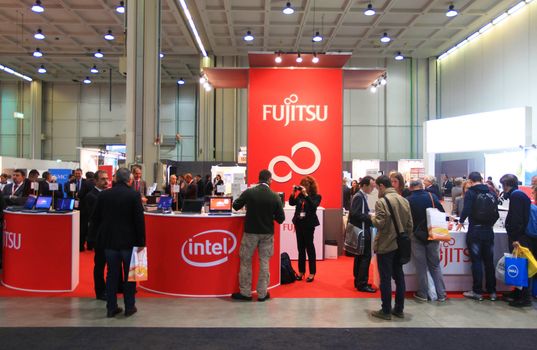 MILAN, ITALY - OCTOBER 17: People visit technologies products exhibition area at SMAU, international fair of business intelligence and information technology October 17, 2012 in Milan, Italy.