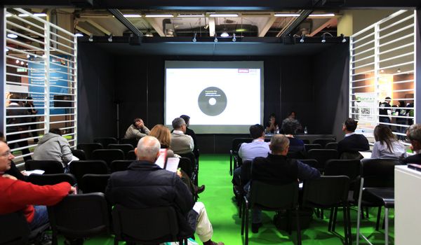 MILAN, ITALY - OCTOBER 17: People attending business meeting during SMAU, international fair of business intelligence and information technology October 17, 2012 in Milan, Italy.