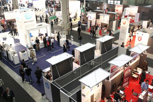 MILAN, ITALY - OCTOBER 17: People visit technologies products exhibition area at SMAU, international fair of business intelligence and information technology October 17, 2012 in Milan, Italy.