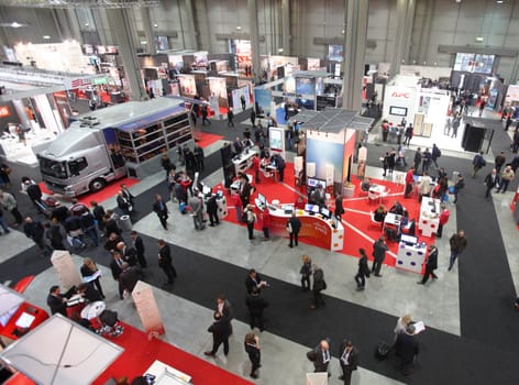 MILAN, ITALY - OCTOBER 17: People visit technologies products exhibition area at SMAU, international fair of business intelligence and information technology October 17, 2012 in Milan, Italy.