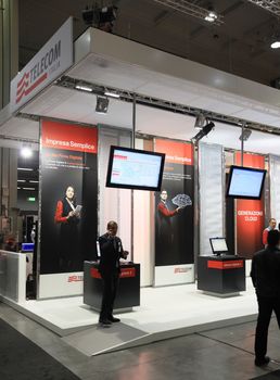 MILAN, ITALY - OCTOBER 17: People visit technologies products exhibition area at SMAU, international fair of business intelligence and information technology October 17, 2012 in Milan, Italy.