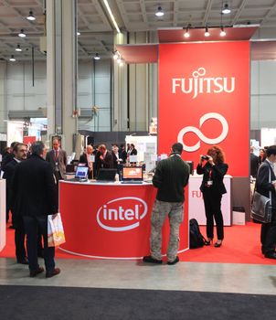 MILAN, ITALY - OCTOBER 17: People visit technologies products exhibition area at SMAU, international fair of business intelligence and information technology October 17, 2012 in Milan, Italy.