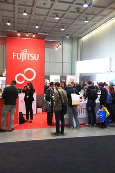 MILAN, ITALY - OCTOBER 17: People visit technologies products exhibition area at SMAU, international fair of business intelligence and information technology October 17, 2012 in Milan, Italy.