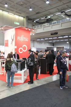 MILAN, ITALY - OCTOBER 17: People visit technologies products exhibition area at SMAU, international fair of business intelligence and information technology October 17, 2012 in Milan, Italy.