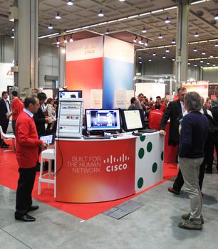 MILAN, ITALY - OCTOBER 17: People visit Cisco technologies products exhibition area at SMAU, international fair of business intelligence and information technology October 17, 2012 in Milan, Italy.