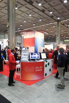 MILAN, ITALY - OCTOBER 17: People visit Cisco technologies products exhibition area at SMAU, international fair of business intelligence and information technology October 17, 2012 in Milan, Italy.