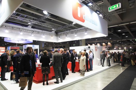 MILAN, ITALY - OCTOBER 17: People visit Olivetti technologies products exhibition area at SMAU, international fair of business intelligence and information technology October 17, 2012 in Milan, Italy.