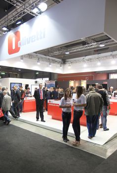 MILAN, ITALY - OCTOBER 17: People visit Olivetti technologies products exhibition area at SMAU, international fair of business intelligence and information technology October 17, 2012 in Milan, Italy.