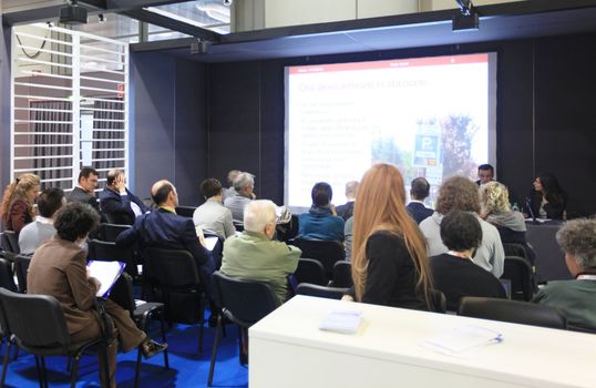 MILAN, ITALY - OCTOBER 17: People attending business meeting during SMAU, international fair of business intelligence and information technology October 17, 2012 in Milan, Italy.