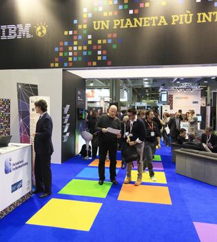 MILAN, ITALY - OCTOBER 17: People visit IBM technologies products exhibition area at SMAU, international fair of business intelligence and information technology October 17, 2012 in Milan, Italy.