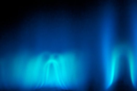 An abstract shot of the blue flame of a gas heater.