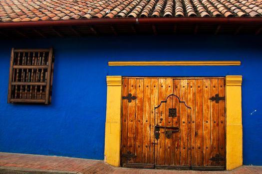 Blue wall in the Spanish colonial style in the neighborhood La Candelaria in Bogota, Colombia.