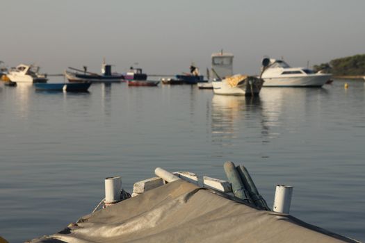 Docked fishing boat with other boats behind
