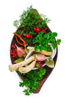 Spices and herbs in a mortar isolated on white background