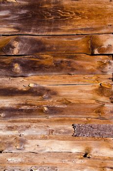 Old abandoned rural house walls made of boards background.