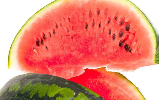Sliced ripe fresh watermelon showing the refreshing watery sweet pink pulp and pips isolated on a white background
