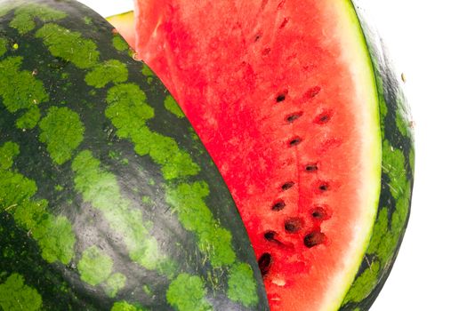 Sliced ripe fresh watermelon showing the refreshing watery sweet pink pulp and pips isolated on a white background