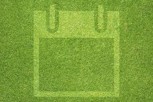 Diskette icon on green grass texture and background 