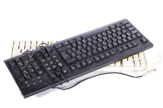 old unwanted computer keyboards on a white background