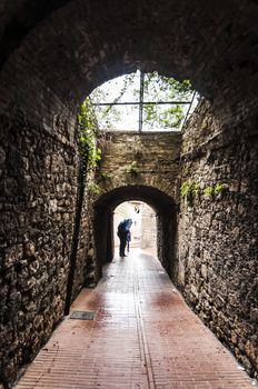 narrow street in a old tuscan village, italy