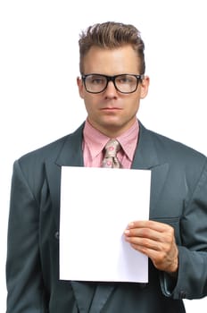 Caucasian businessman with glasses in fashionable suit holds blank paper with copy space on white background