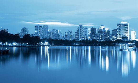 City at night, panoramic scene of downtown reflected in water,thailand