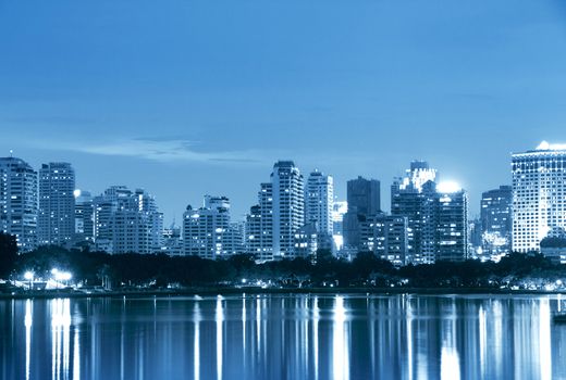 City at night, panoramic scene of downtown reflected in water,thailand