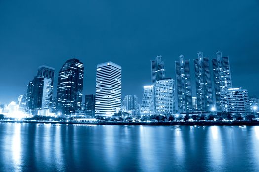 City at night, panoramic scene of downtown reflected in water,thailand