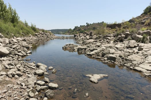 Rocky riverbank of Tagus river near Almourol castle, Portugal