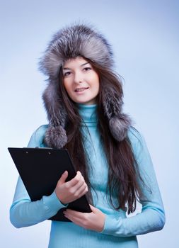 woman winter with clipboard on blue background