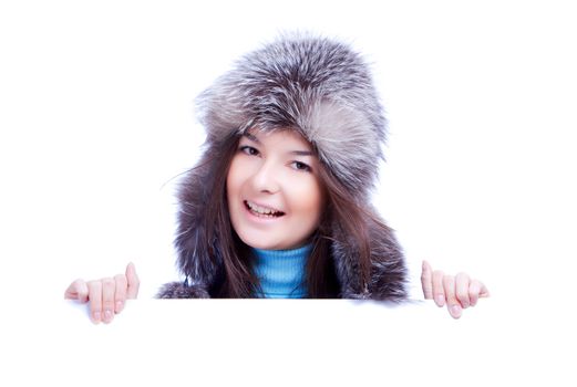 smiling winter woman in fur cap hold banner isolated