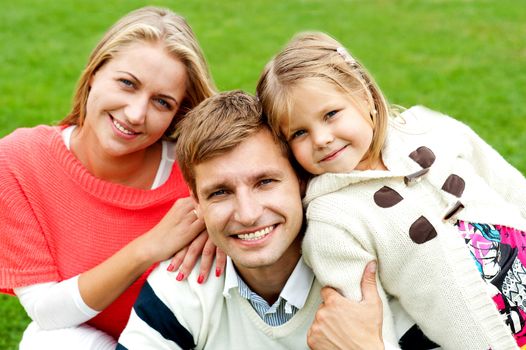 Joyous family of three. Loving and caring. Outdoor shot