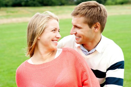 Couple admiring each other and smiling heartily. Lost in each other