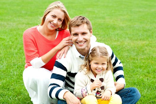 Outdoor happy caucasian family relaxing. Bright sunny day