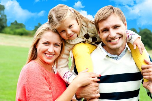 Beautiful happy caucasian family of three. Father, mother and daughter