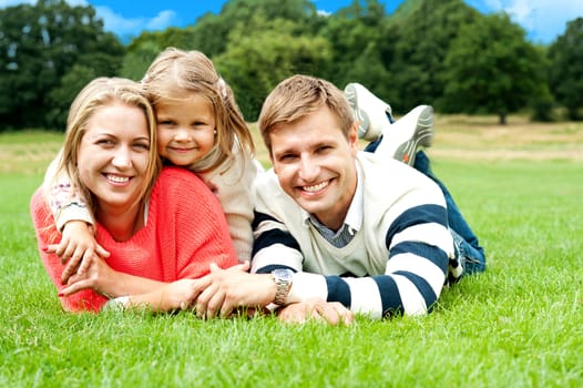 Joyous family in a park enjoying day out. Sunny spring day