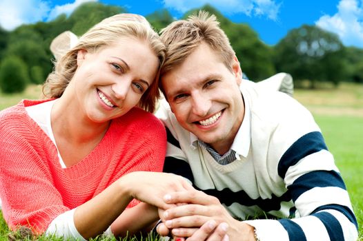 Attractive young couple in love. Holding hands. Nature background