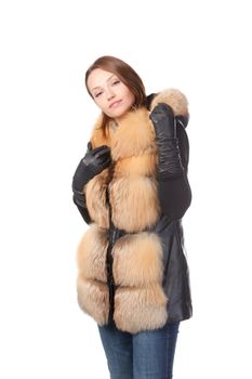 Stylish woman in winter fashion wearing gloves and a fur trimmed jacket isolated on white