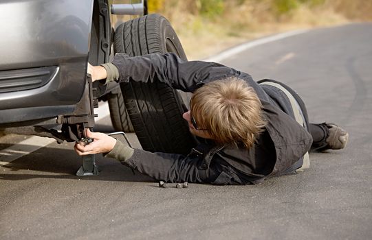Changing wheels on a car on the roadside