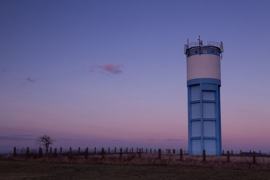 Historic water reservoir brick tower at sunset