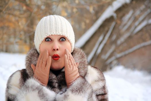 Portrait of surprised woman in winter coat