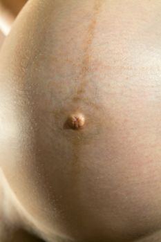 closeup stomach and navel of pregnant woman