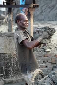 SARBERIA,INDIA, JANUARY 14: Brick field. Laborers are carrying deposited soil for making raw brick. on January 14, 2009 in Sarberia, West Bengal, India.