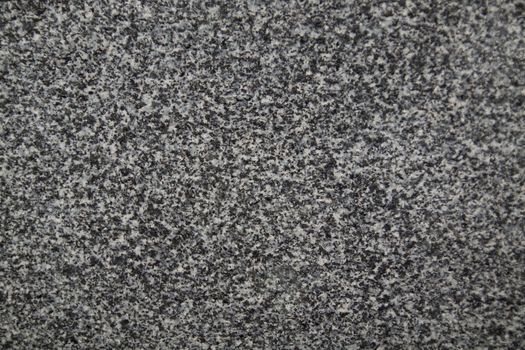 Closeup of dark grey granite texture background