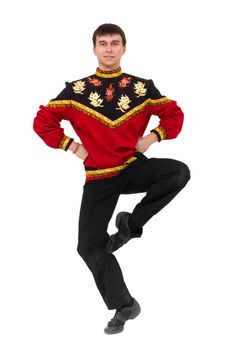 Attractive man wearing a folk russian costume dancing against isolated white background